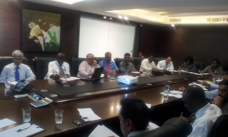 Leadership team in a boardroom discussing a stalled initiative — diagnosing Execution Decay