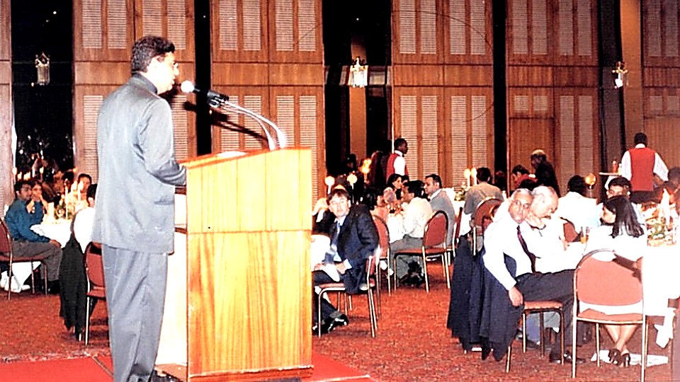 Vijay Mistri delivering a keynote to a live conference audience