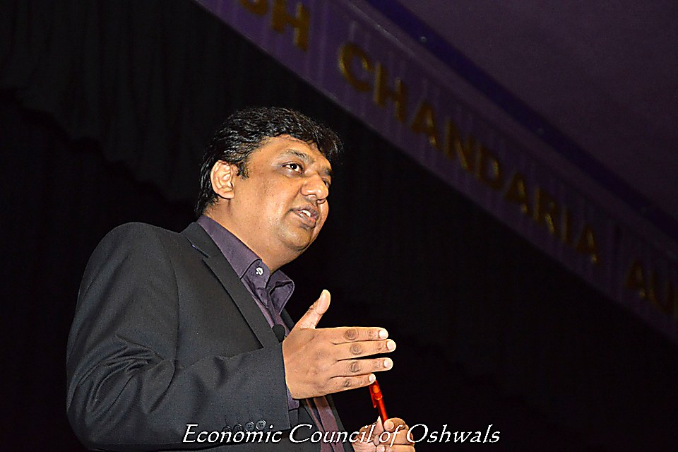 Vijay Mistri at the podium during a leadership conference